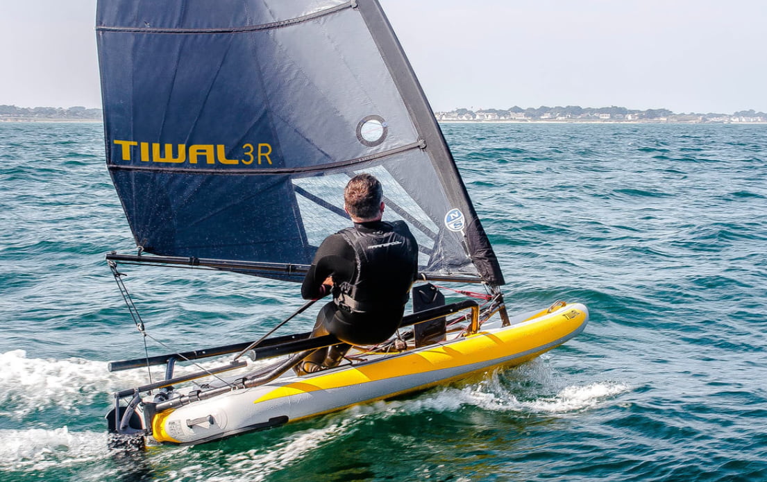 Man on the Small Sailboat on the sea waves