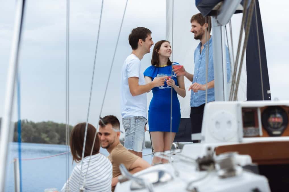 A group enjoying a conversation on a sailboat deck