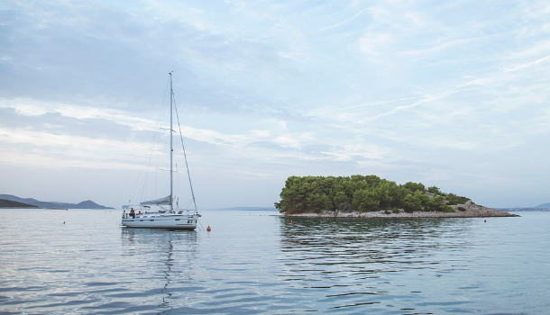 Small sailboat on the water near the island