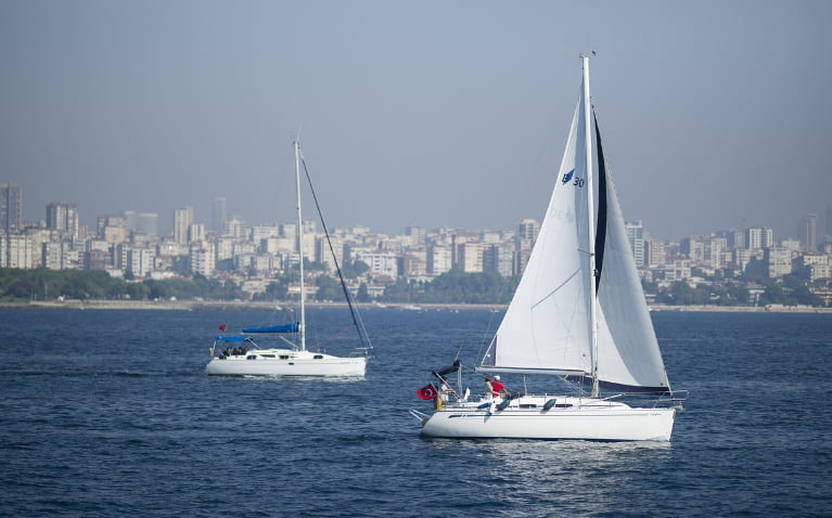 Two small sailboats on the river