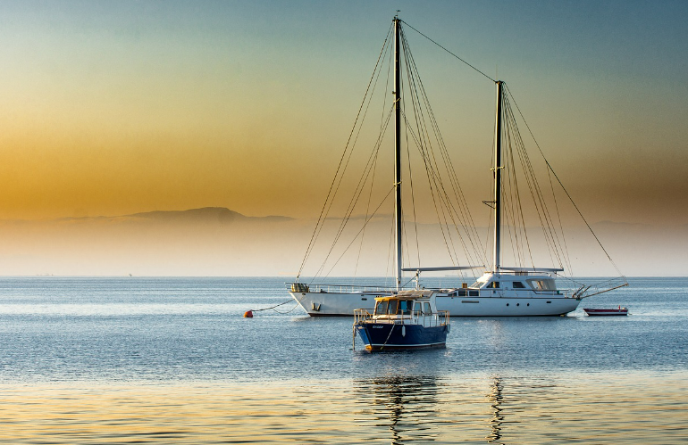 Two sailboats moored on waters