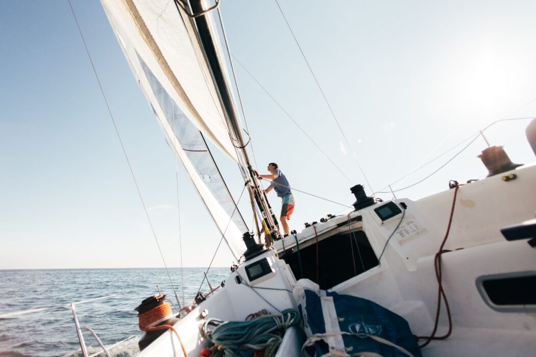 Man on yacht and folds sails